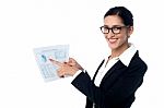 Business Lady Pointing Out Profits Graph On Report Stock Photo