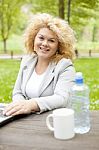 Business Lady Sitting In Park Stock Photo