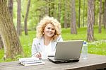 Business Lady Using Laptop In Park Stock Photo