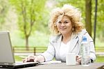 Business Lady Using Laptop In Park Stock Photo