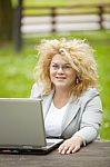 Business Lady Using Laptop In Park Stock Photo