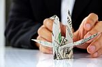 Business Man Hand Holding Origami Paper Cranes Stock Photo