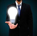 Business Man Holding Light Bulb Stock Photo