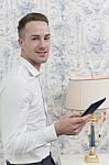 Business Man In A Hotel Room With Tablet Stock Photo