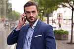 Business Man On The Street And Mobile Phone Stock Photo