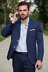 Business Man On The Street And Mobile Phone Stock Photo