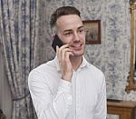 Business Man Sitting In A Hotel Room And Phones Stock Photo