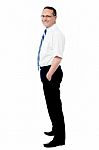 Business Man Standing With His Hands In The Pockets Stock Photo