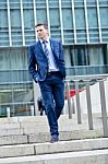 Business Man Walking Down Some Steps Stock Photo