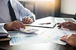 Business Man Working At Office With Laptop, Tablet And Graph Dat Stock Photo