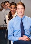 Business People Sitting In A Row Stock Photo