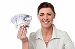 Business Woman Holding Fan Of Currency Notes Stock Photo