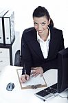 Business Woman Making Notes And Looking At The Camera Up Stock Photo