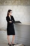 Business Woman Standing Thoughtful In A Building Stock Photo