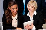 Business Women Browsing On Tablet Device Stock Photo