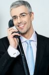 Businessman Answering A Call Stock Photo