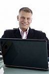 Businessman At Desk With Laptop Stock Photo