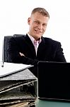 Businessman At Desk With Laptop Stock Photo