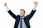 Businessman Celebrating Success With Arms Up Stock Photo