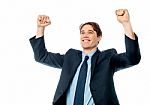 Businessman Celebrating Success With Arms Up Stock Photo