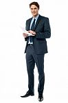 Businessman Checking Data Printed On The List Stock Photo