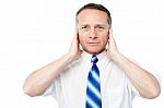 Businessman Covering His Ears With His Hands Stock Photo