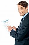 Businessman Cross-checking Annual Report Stock Photo