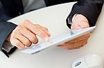 Businessman Finger Pointing To The Screen Of A Digital Tablet Stock Photo