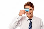 Businessman Hiding His Eye With Credit Card Stock Photo