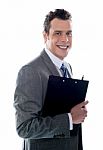 Businessman Holding Clipboard Stock Photo