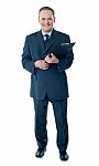 Businessman holding clipboard Stock Photo