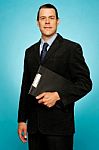 Businessman Holding Clipboard Stock Photo