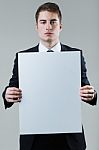 Businessman Holding Empty White Placard Showing Copy Space Stock Photo