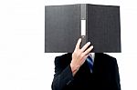 Businessman Holding File Pad And Cover His Face Stock Photo