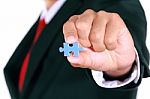 Businessman Holding Jigsaw Stock Photo