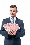 Businessman Holding Play Cards Stock Photo