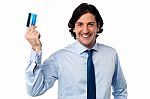 Businessman Holding Up His Credit Card Stock Photo