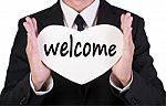 Businessman Holding Welcome Card Stock Photo