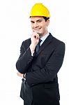 Businessman Holds His Hand On His Chin Stock Photo