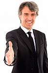 Businessman Holds Out His Hand Stock Photo