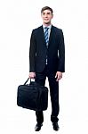 Businessman In Black Suit Posing With Bag Stock Photo