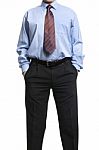 Businessman In Blue Shirt Standing With Hands In Pockets Stock Photo