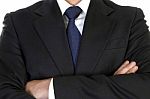 Businessman In Suit With Crossed Arms Stock Photo