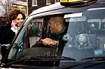 Businessman Interacting With Taxi Driver Stock Photo