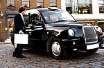 Businessman Interacting With Taxi Driver Stock Photo