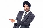 Businessman Pointing Away Over White Stock Photo