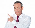 Businessman Pointing Backward Stock Photo