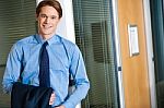 Businessman Posing Casually At Office Stock Photo