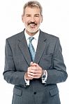 Businessman Posing With Clasped Hands Stock Photo