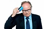 Businessman Scratching His Forehead With Plastic Card Stock Photo